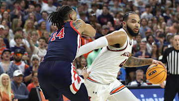 Feb 26, 2025; Auburn, Alabama, USA;  Auburn Tigers center Johni Broome (4) goes for a shot as Mississippi Rebels guard Dre Davis (14) defends during the second half at Neville Arena. Mandatory Credit: John Reed-Imagn Images