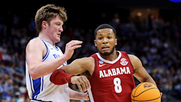Mar 29, 2025; Newark, NJ, USA; Alabama Crimson Tide guard Chris Youngblood (8) drives to the basket against Duke Blue Devils guard Kon Knueppel (7) during the second half in the East Regional final of the 2025 NCAA tournament at Prudential Center. Mandatory Credit: Vincent Carchietta-Imagn Images