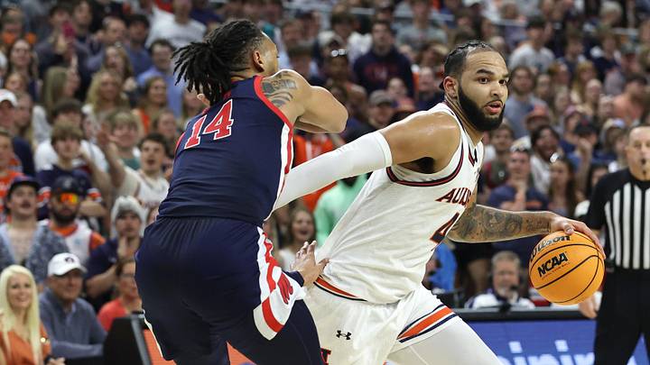 Feb 26, 2025; Auburn, Alabama, USA;  Auburn Tigers center Johni Broome (4) goes for a shot as Mississippi Rebels guard Dre Davis (14) defends during the second half at Neville Arena. Mandatory Credit: John Reed-Imagn Images