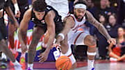 Feb 15, 2025; Champaign, Illinois, USA;  Michigan State Spartans guard Jefremy Fears Jr. (1) and Illinois Fighting Illini guard Kylan Boswell (4) go to the floor for a loose ball during the second half at State Farm Center. Mandatory Credit: Ron Johnson-Imagn Images