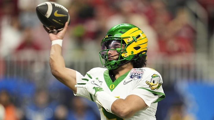Jan 9, 2026; Atlanta, GA, USA; Oregon Ducks quarterback Dante Moore (5) passes against the Indiana Hoosiers during the third quarter of the 2025 Peach Bowl and semifinal game of the College Football Playoff at Mercedes-Benz Stadium. Mandatory Credit: Dale Zanine-Imagn Images