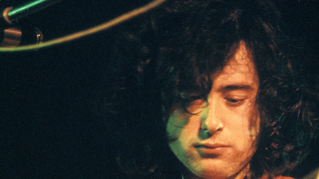 Jimmy Page of Led Zeppelin plays the guitar