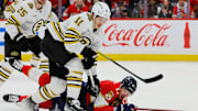 May 8, 2024; Sunrise, Florida, USA; Florida Panthers center Evan Rodrigues (17) dives for the puck against Boston Bruins center Trent Frederic (11) during the first period in game two of the second round of the 2024 Stanley Cup Playoffs at Amerant Bank Arena. Mandatory Credit: Sam Navarro-Imagn Images