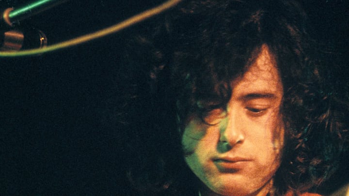 Jimmy Page of Led Zeppelin plays the guitar