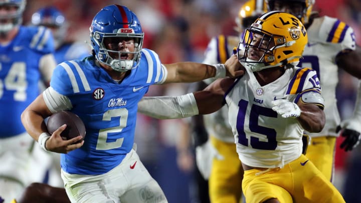 Sep 30, 2023; Oxford, Mississippi, USA; Mississippi Rebels quarterback Jaxson Dart (2) runs the ball as LSU Tigers defensive back Sage Ryan (15) attempts to make the tackle during the second half  at Vaught-Hemingway Stadium. Mandatory Credit: Petre Thomas-USA TODAY Sports