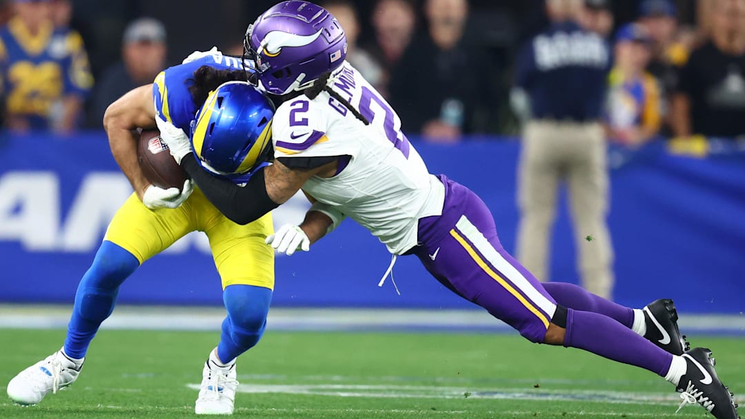 Jan 13, 2025; Glendale, AZ, USA; Los Angeles Rams wide receiver Puka Nacua (17) makes a catch against Minnesota Vikings cornerback Stephon Gilmore (2) during the second half in an NFC wild card game at State Farm Stadium. Mandatory Credit: Mark J. Rebilas-Imagn Images