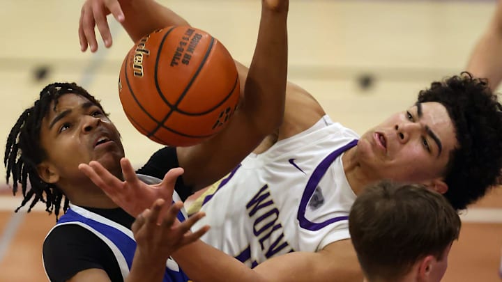 Bremerton’s Jaydon Turner (left) and Sequim’s Jericho Julmist (right) battle for control of a rebound during their game at North Kitsap High School in Poulsbo, Wash. on Tuesday, Feb. 11, 2025.