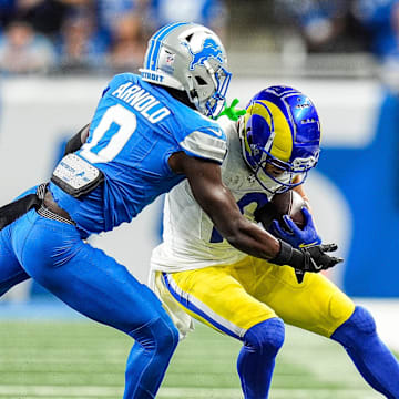 Detroit Lions cornerback Terrion Arnold (0) tackles Los Angeles Rams wide receiver Cooper Kupp (10) 