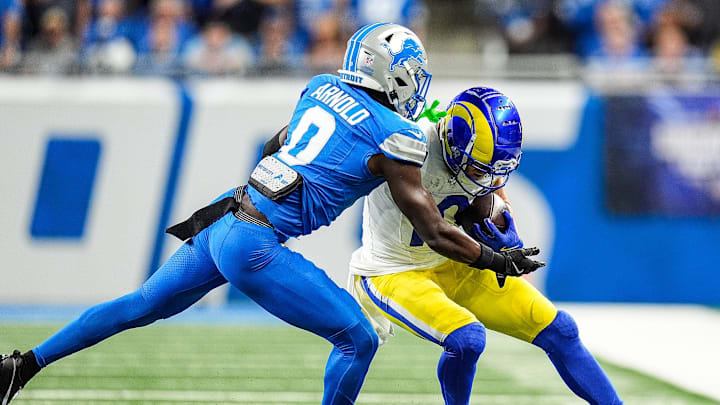 Detroit Lions cornerback Terrion Arnold (0) tackles Los Angeles Rams wide receiver Cooper Kupp (10) 