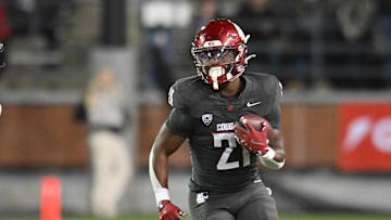 Nov 9, 2024; Pullman, Washington, USA; Washington State Cougars running back Wayshawn Parker (21) runs the ball against the Utah State Aggies in the second half at Gesa Field at Martin Stadium. Mandatory Credit: James Snook-Imagn Images