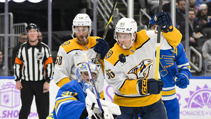 Dec 15, 2025; St. Louis, Missouri, USA; St. Louis Blues goaltender Joel Hofer (30) defends the net against Nashville Predators left wing Michael Bunting (58) and left wing Erik Haula (56) during the first period at Enterprise Center. Mandatory Credit: Jeff Curry-Imagn Images