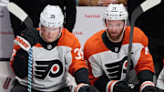 Dec 31, 2024; San Jose, California, USA; Philadelphia Flyers right wing Matvei Michkov (39) and Philadelphia Flyers center Sean Couturier (14) watch game play from the bench against the San Jose Sharks during the third period at SAP Center at San Jose. Mandatory Credit: Robert Edwards-Imagn Images