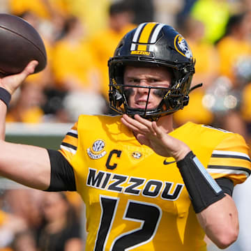 Sep 14, 2024; Columbia, Missouri, USA; Missouri Tigers quarterback Brady Cook (12) warms up against the Boston College Eagles prior to a game at Faurot Field at Memorial Stadium. Mandatory Credit: Denny Medley-Imagn Images