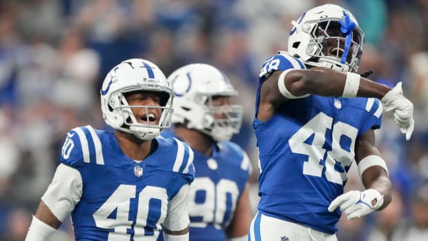 Colts safety Ronnie Harrison Jr. (blue jersey with white pants/helmet) celebrates after a big play with his teammates. 