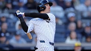 Mar 27, 2025; Bronx, New York, USA; New York Yankees center fielder Cody Bellinger (35) follows through on an RBI sacrifice fly during the seventh inning against the Milwaukee Brewers at Yankee Stadium. 