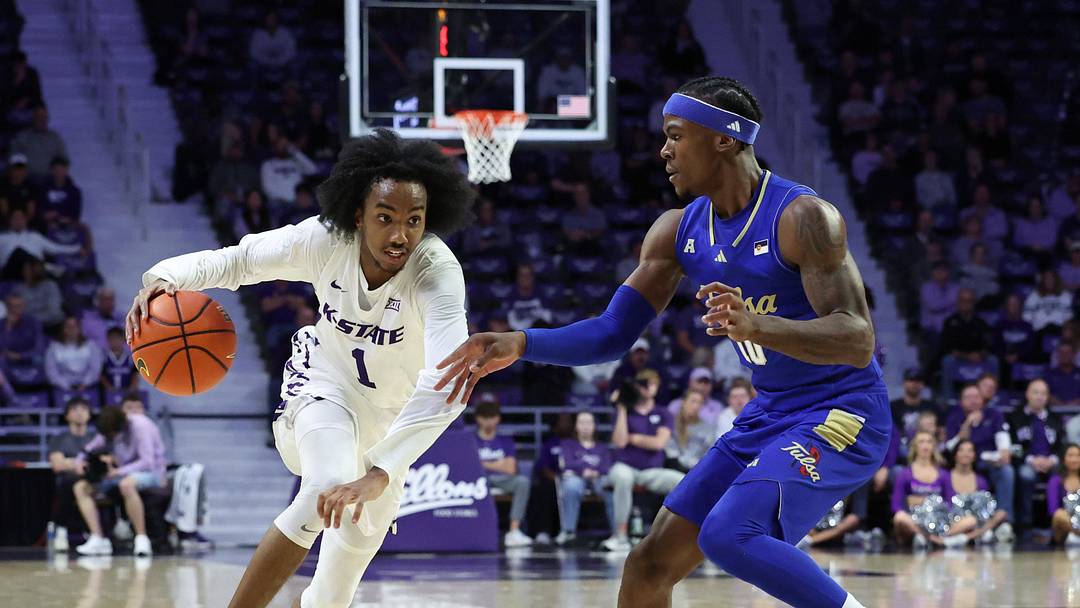 Nov 17, 2025; Manhattan, Kansas, USA; Kansas State Wildcats guard Abdi Bashir Jr. (1) dribbles against Tulsa Golden Hurricane guard Tylen Riley (10) during the first half at Bramlage Coliseum. Mandatory Credit: Scott Sewell-Imagn Images