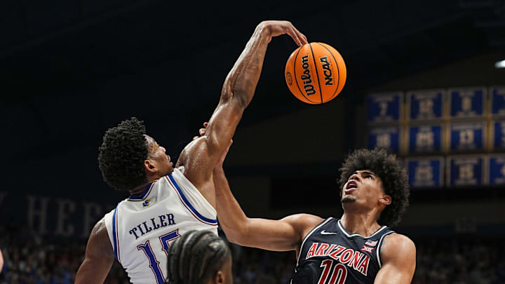 Feb 9, 2026; Lawrence, Kansas, USA; Kansas Jayhawks forward Bryson Tiller (15) blocks the shot Arizona Wildcats forward Koa Peat (10) during the first half at Allen Fieldhouse. Mandatory Credit: Jay Biggerstaff-Imagn Images