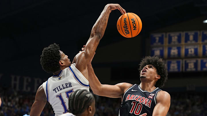 Feb 9, 2026; Lawrence, Kansas, USA; Kansas Jayhawks forward Bryson Tiller (15) blocks the shot Arizona Wildcats forward Koa Peat (10) during the first half at Allen Fieldhouse. 