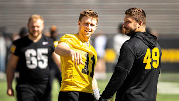 Apr 26, 2025; Iowa City, IA, USA; Iowa quarterback Mark Gronowski (11) talks with defensive lineman Ethan Hurkett (49) during a spring NCAA football open practice at Kinnick Stadium. Mandatory Credit: Joseph Cress/For the Register
