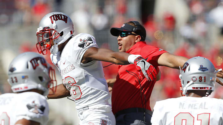 UNLV Rebels linebacker Javin White (16) celebrates a fumble recovery with a member of the coaching staff during the fourth quarter against the Ohio State Buckeyes at Ohio Stadium. Ohio State won 54-21. UNLV Rebels linebacker Javin White (16) celebrates a fumble recovery with a member of the coaching staff during the fourth quarter against the Ohio State Buckeyes at Ohio Stadium. Ohio State won 54-21.