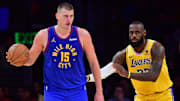 Apr 25, 2024; Los Angeles, California, USA; Denver Nuggets center Nikola Jokic (15) controls the ball against Los Angeles Lakers forward LeBron James (23)  during the second half in game three of the first round for the 2024 NBA playoffs at Crypto.com Arena. Mandatory Credit: Gary A. Vasquez-Imagn Images