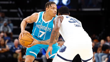 Oct 10, 2024; Memphis, Tennessee, USA; Charlotte Hornets forward Keyontae Johnson (7) handle the ball as Memphis Grizzlies guard Marcus Smart (36) defends during the first half at FedExForum. Mandatory Credit: Petre Thomas-Imagn Images