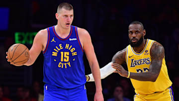 Apr 25, 2024; Los Angeles, California, USA; Denver Nuggets center Nikola Jokic (15) controls the ball against Los Angeles Lakers forward LeBron James (23)  during the second half in game three of the first round for the 2024 NBA playoffs at Crypto.com Arena. Mandatory Credit: Gary A. Vasquez-Imagn Images