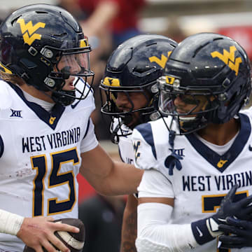 Nov 1, 2025; Houston, Texas, USA; West Virginia Mountaineers quarterback Scotty Fox Jr. (15) celebrates his touchdown with wide receiver Jarod Bowie (7) and teammates against the Houston Cougars in the first half at TDECU Stadium. Mandatory Credit: Thomas Shea-Imagn Images