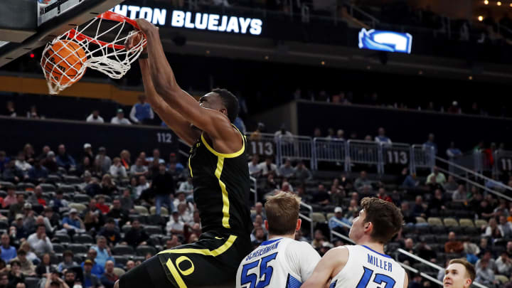 Mar 23, 2024; Pittsburgh, PA, USA; Oregon Ducks center N'Faly Dante (1) dunks the ball against Creighton Bluejays guard Baylor Scheierman (55) during the second half in the second round of the 2024 NCAA Tournament at PPG Paints Arena.