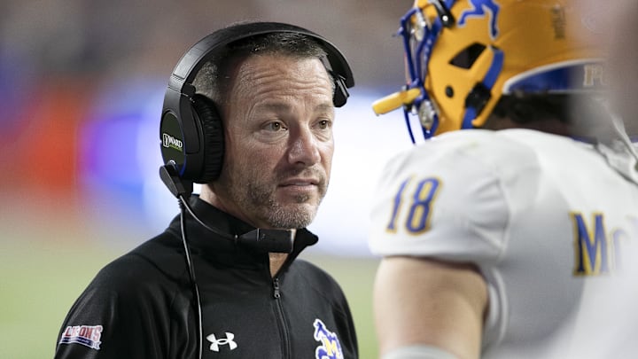 Sep 9, 2023; Gainesville, Florida, USA; McNeese State Cowboys head coach Gary Goff talks with McNeese State Cowboys quarterback Nate Glantz (18) on the sideline during first half action at Ben Hill Griffin Stadium. Mandatory Credit: Alan Youngblood-Imagn Images