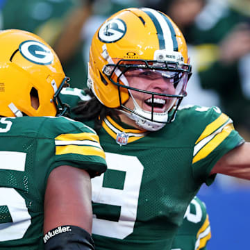 Green Bay Packers wide receiver Christian Watson (9) celebrates with Aaron Banks after his go-ahead touchdown.