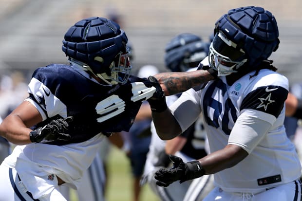 Dallas Cowboys defensive end Marshawn Kneeland and offensive tackle Tyler Guyton battle during training camp at the River Rid
