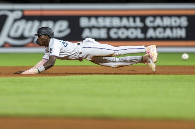 Jazz Chisholm Jr. slides into second base.