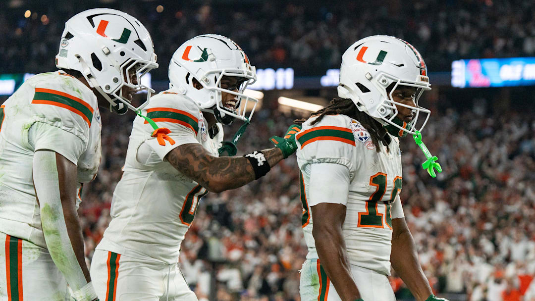 Miami Hurricanes wide receiver Keelan Marion (0) pats Malachi Toney (10) on the back after his touchdown during the CFP Fiesta Bowl at the State Farm Stadium, in Glendale, Ariz., on Thursday, Jan. 8, 2026.