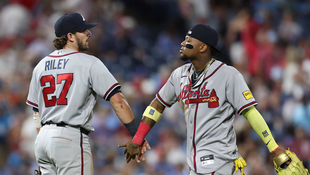 Apr 17, 2026; Philadelphia, Pennsylvania, USA; Atlanta Braves right fielder Ronald Acuña Jr. (13) and third baseman Austin Riley (27) react after a 9-0 win against the Philadelphia Phillies at Citizens Bank Park. Mandatory Credit: Bill Streicher-Imagn Images