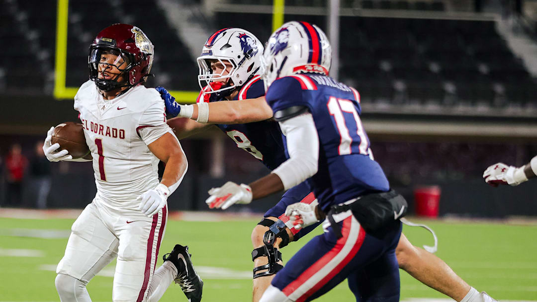 El Dorado’s Ryan Estrada carries the ball against Richland’s Gage Goodwin pushes Estrada out of bounds in a 5A D1 playoff game, Nov. 21, 2025, at the Jones AT&T Stadium in Lubbock.