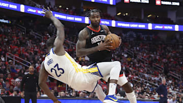 Dec 11, 2024; Houston, Texas, USA; Houston Rockets forward Tari Eason (17) controls the ball as Golden State Warriors forward Draymond Green (23) loses balance during the fourth quarter at Toyota Center. Mandatory Credit: Troy Taormina-Imagn Images