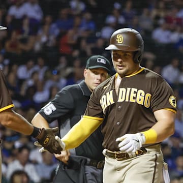 Jun 14, 2022; Chicago, Illinois, USA; San Diego Padres first baseman Luke Voit (45) is congratulated by first baseman Eric Hosmer (30) after hitting a two-run home run against the Chicago Cubs during the sixth inning at Wrigley Field. Mandatory Credit: Kamil Krzaczynski-Imagn Images