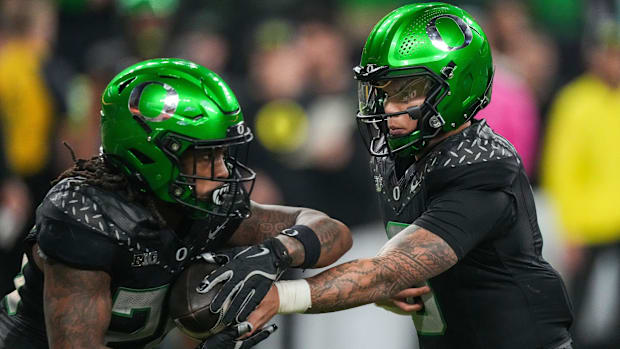 Oregon Ducks quarterback Dillon Gabriel hands off the ball to running back Jordan James during the Big Ten Championship game