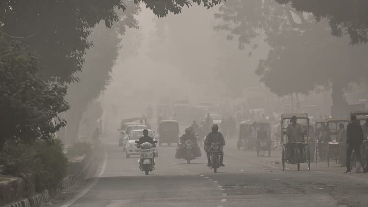 Air pollution fogs road in Delhi, India.