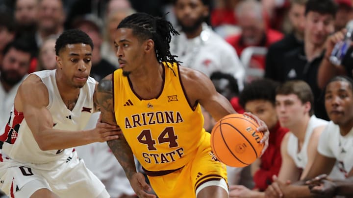 Feb 12, 2025; Lubbock, Texas, USA;  Arizona State Sun Devils guard Adam Miller (44) dribbles the ball around Texas Tech Red Raiders guard Chance McMillian (0) in the first half at United Supermarkets Arena. Mandatory Credit: Michael C. Johnson-Imagn Images