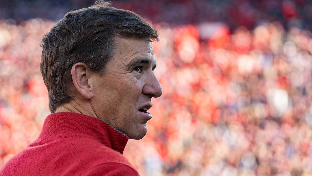 Former NFL QB Eli Manning stands on the sideline before the first round of the College Football Playoff.