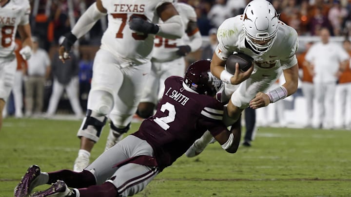 Oct 25, 2025; Starkville, Mississippi, USA; Texas Longhorns quarterback Arch Manning (16) runs the ball as Mississippi State Bulldogs defensive back Isaac Smith (2) makes the tackle during overtime at Davis Wade Stadium at Scott Field. Mandatory Credit: Petre Thomas-Imagn Images