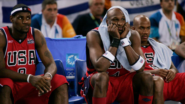 LeBron James, Lamar Odom, and Stephon Marbury sit on the bench during the 2004 Olympics.