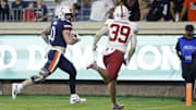 Sep 20, 2025; Charlottesville, Virginia, USA; Virginia Cavaliers tight end Sage Ennis (0) scores a touchdown as Stanford Cardinal safety Charlie Eckhardt (39) chases during the third quarter at Scott Stadium. Mandatory Credit: Geoff Burke-Imagn Images