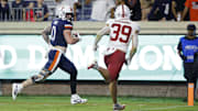 Sep 20, 2025; Charlottesville, Virginia, USA; Virginia Cavaliers tight end Sage Ennis (0) scores a touchdown as Stanford Cardinal safety Charlie Eckhardt (39) chases during the third quarter at Scott Stadium. Mandatory Credit: Geoff Burke-Imagn Images