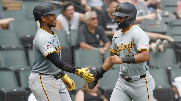 Jul 14, 2024; Chicago, Illinois, USA; Pittsburgh Pirates second baseman Nick Gonzales (39) celebrates with third baseman Ke'Bryan Hayes (13) after scoring against the Chicago White Sox during the seventh inning at Guaranteed Rate Field. Mandatory Credit: Kamil Krzaczynski-USA TODAY Sports