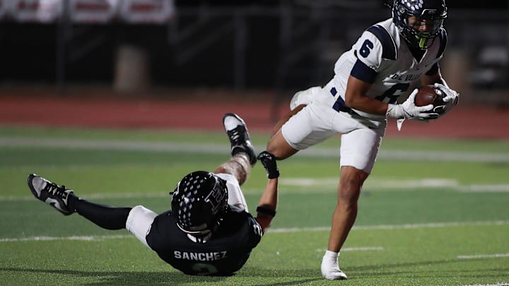 Brandon Sanchez of J.M. Hanks trips up Del Valle's Ivan Lopez. 
