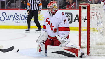 Apr 25, 2025; Newark, New Jersey, USA; Carolina Hurricanes goaltender Frederik Andersen (31) makes a save against the New Jersey Devils during the first overtime in game three of the first round of the 2025 Stanley Cup Playoffs at Prudential Center. Mandatory Credit: Ed Mulholland-Imagn Images