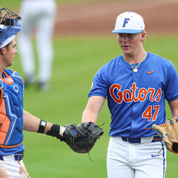 Florida Gators catcher Luke Heyman and pitcher Aidan King during the team's win over Harvard in the first game of Saturday's double-header.
